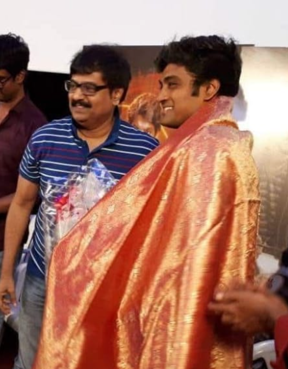 Vijay Ashokan being felicitated with a shawl at an event